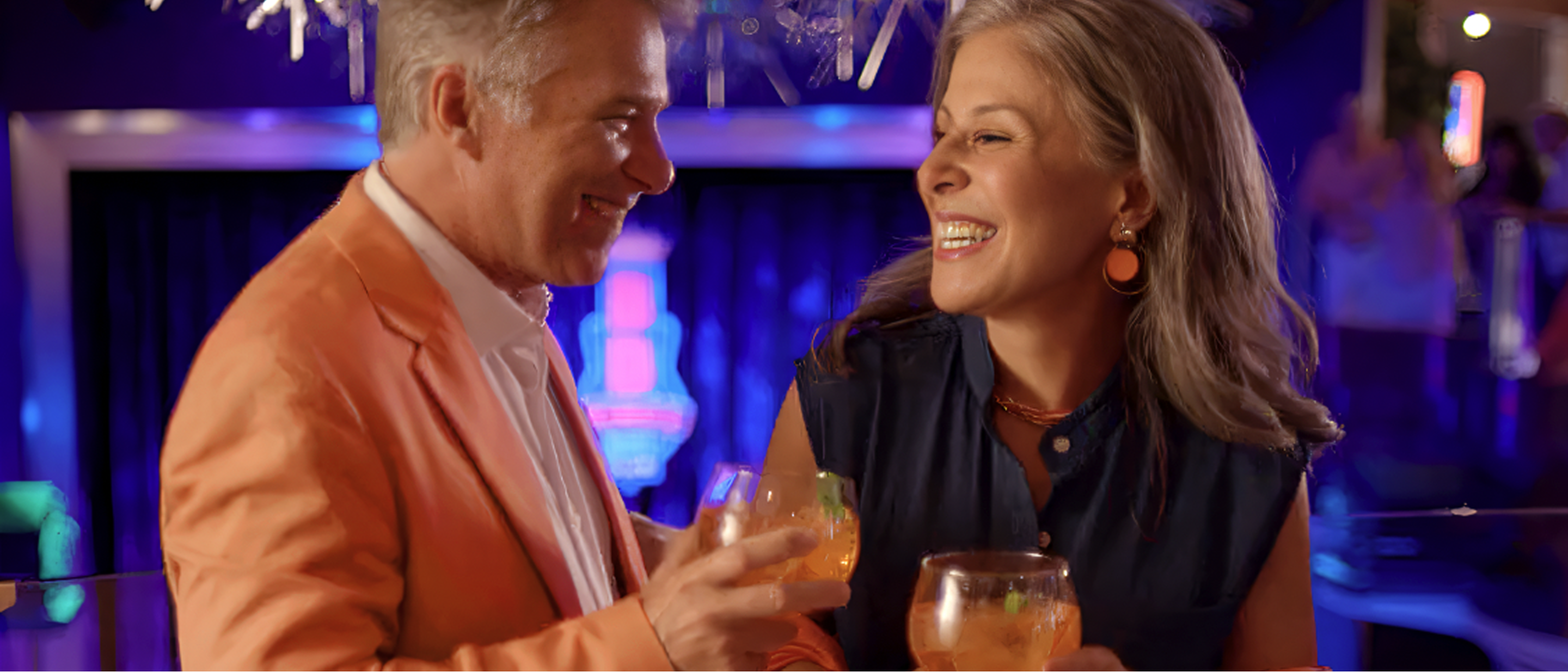 Couple enjoying onboard entertainment.