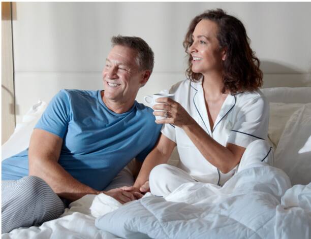 Couple drinking coffee in bed